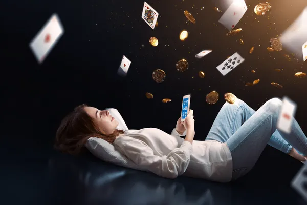 A young woman relaxing with her phone while dynamic casino elements float around her, illustrating the smooth mobile experience offered by the 1777DET app.